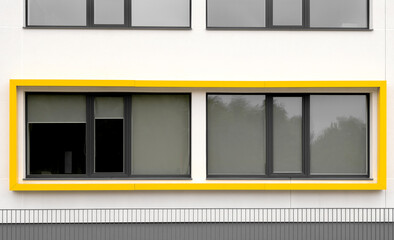 Modern building facade with yellow window detail, abstract architecture