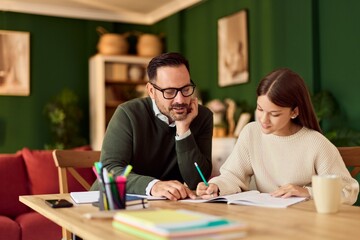 Naklejka premium Father and Daughter Studying Together At Home: Focused Tutor And Student Working On Homework