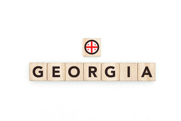 Wooden blocks bearing the name and flag of Georgia. Georgian and Asian Culture, national identity, travel, and geography in a copy space design.