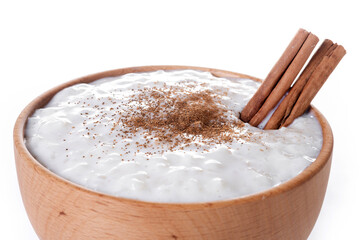 Rice pudding on wooden bowl isolated on white background