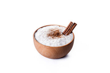 Rice pudding on wooden bowl isolated on white background