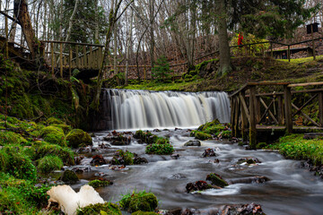 A long exposure view of a waterfall in a small rapid river, autumn landscape, November in nature,...