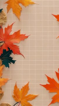 Vertical video: Breeze sending orange maple leaf drifting across grid to leaf cluster, copy space