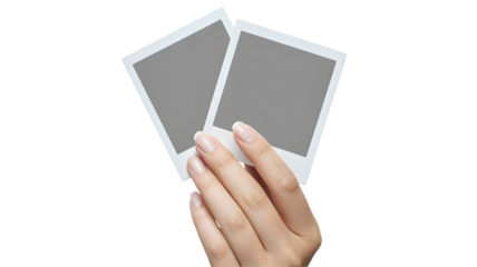 Hand holding two blank instant photo prints isolated on transparent background