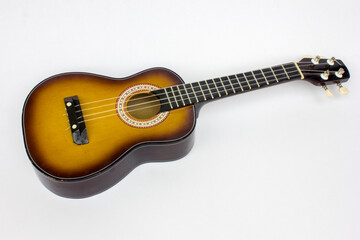 Fototapeta premium Ukulele isolated on white background with copy space, a compact instrument for musical expression