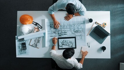 Top view of civil engineer working together to plan building design. Top down aerial view of...