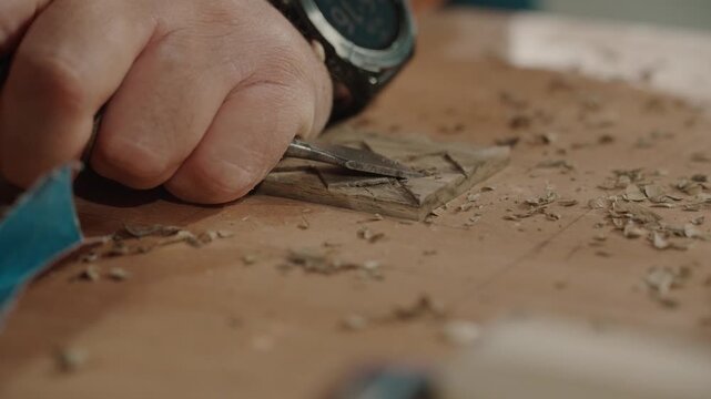 Close-up of hand carving wood, creating art with focus and precision