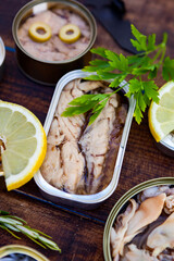 Cans of preserves. In the center a can of mackerel in oil