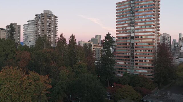 Low rising aerial shot above Stanley Park during moonrise in Vancouver, British Columbia, Canada. 4K