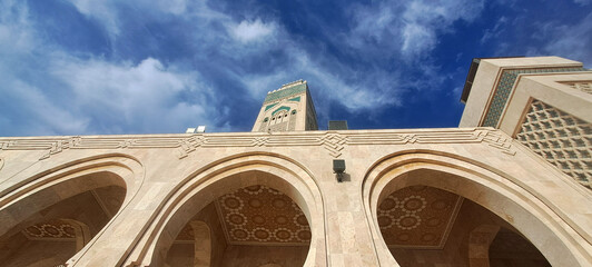 Hassan ii mosque minaret rising above arches