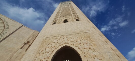 Hassan ii mosque minaret reaching blue sky in casablanca