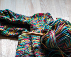 colorful knitting yarn and knitting needles, knitwear fashion, wool socks and needles, knitting hobby, handcraft clothing, handcraft concept