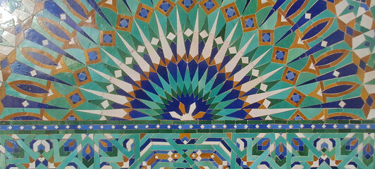 Moroccan zellige mosaic with intricate green and blue geometric pattern. hassan ii mosque