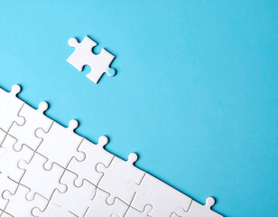 Conceptual illustration of an economic recession, with a hand analyzing a declining stock market chart with a magnifier