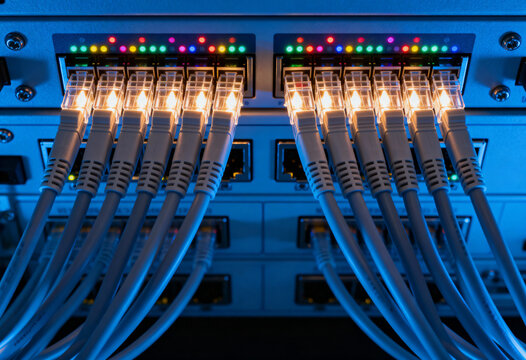 High speed ethernet cables connected to network switches with glowing indicator lights in a modern data center environment - Powered by Adobe