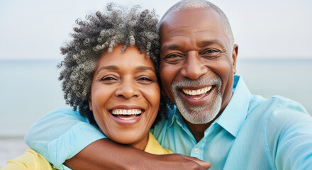 Happy senior couple embracing and smiling together outdoors near the water, reflecting love, joy, and healthy active lifestyles