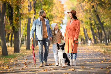 Happy family with dog in autumn park
