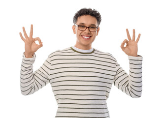 Young man in eyeglasses showing OK on white background