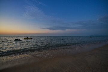 Boats mooring on beach at sunset in penang island