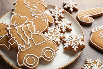 Tasty gingerbread cookies and festive decor on wooden table, closeup