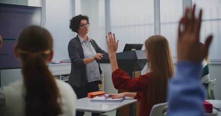 Female Educator in Computer Programming Class Presents Software Code on Smartboard, Engaging Students in Discussion. Concept STEM Education, Interactive Learning, and Innovation in Teaching Methods.