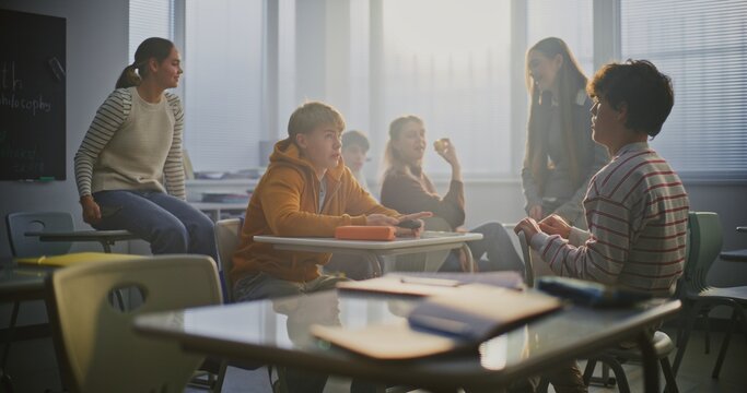Two Male Students Arm Wrestle at Desk During Break, Surrounded by Classmates Cheering and Filming on Smartphone. Concept of Youth Energy, Competition, Friendship, and Social Interaction. Static Shot. - Powered by Adobe