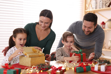 Happy family with Christmas gifts at home