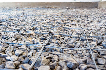 Endless grid of steel lines over stone suggesting the scale of human planning and creation