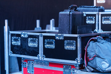 Concert gear boxes with wheels on the stage, used for transporting and protecting equipment during event setup