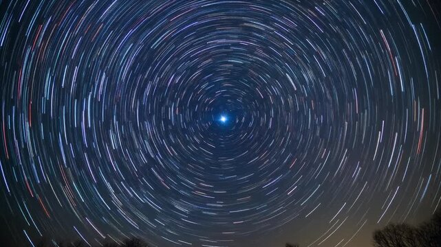 Star trails rotating in a circular motion around the North Star Polaris in a night sky timelapse.