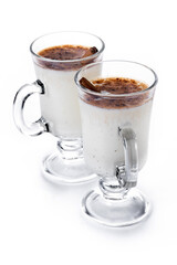 Eggnog with Cinnamon in glass isolated on white background. Christmas drink