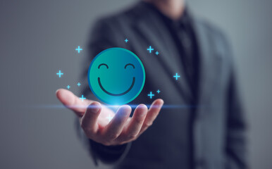 Businessman holding a glowing smiley face icon representing positive thinking, mental wellness, and emotional balance. Ideal for workplace happiness, self-care, and motivation themes.