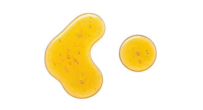 Golden textured cosmetic serum drops or natural honey elixir with shimmering particles