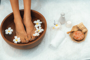 Panorama top view woman indulges in blissful foot massage at luxurious spa salon while masseur give reflexology therapy in gentle day light ambiance resort or hotel foot spa. Quiescent