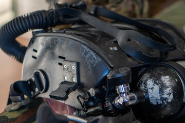 A metal oxygen cylinder with a regulator is used in army underwater systems.