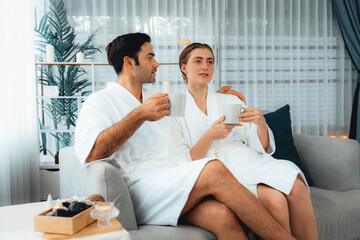 Beauty or body treatment spa salon vacation lifestyle concept with couple wearing bathrobe relaxing...