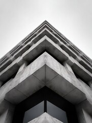 Dramatic low-angle shot of geometric concrete building with strong symmetrical design