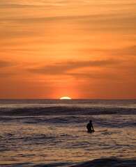 Surfers at sunset