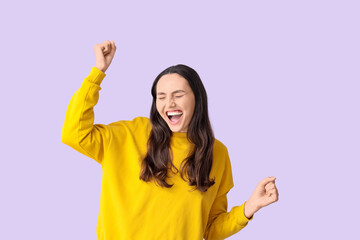 Happy young woman screaming on lilac background
