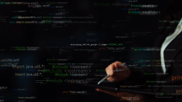 Close-up of a hand using a tablet with floating lines of code in a dark environment, showcasing the complexity and creativity involved in software development. Xenic