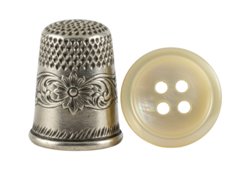 Isolated Sewing notions, a thimble and mother-of-pearl button for needlework and crafts