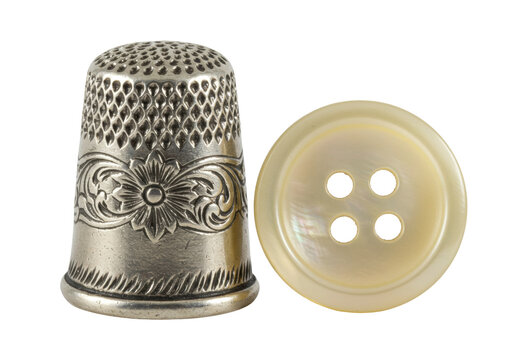 Isolated Sewing notions, a thimble and mother-of-pearl button for needlework and crafts