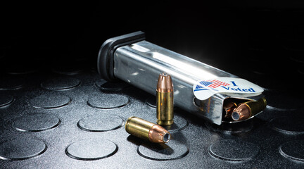 Bright stainless pistol magazine loaded after voting