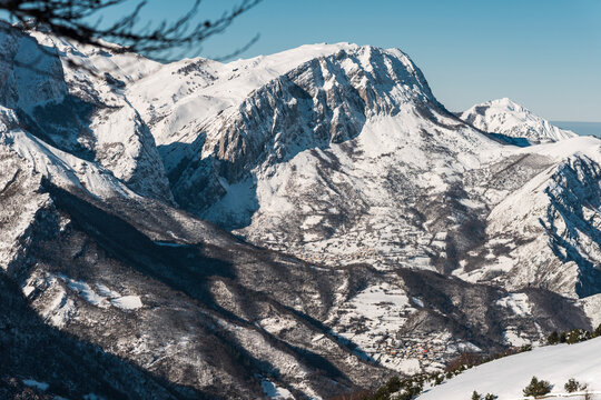 Vast frozen valley beneath monumental snowy peaks