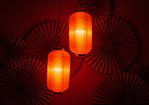 Two glowing red lanterns hang against a dramatic backdrop of red paper fans. Festive Chinese New Year decoration