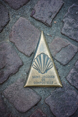 old metal on stone sign, camino de Santiago 
