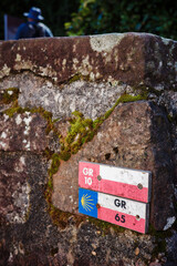 trail sign on a rock