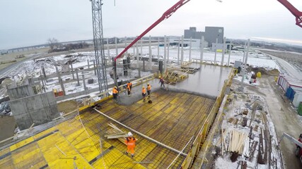 Aerial view of office development in Poland, workers pouring reinforced concrete slab. Real estate growth, urban infrastructure, EU investment. - Powered by Adobe