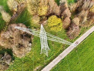 Aerial View of High Voltage Power Line Tower in Green Landscape