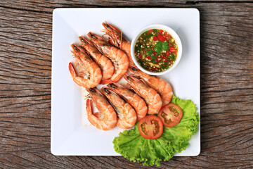 Fresh sea shrimp grilled over charcoal until cooked, served with Thai seafood sauce, Food photography for use in menus